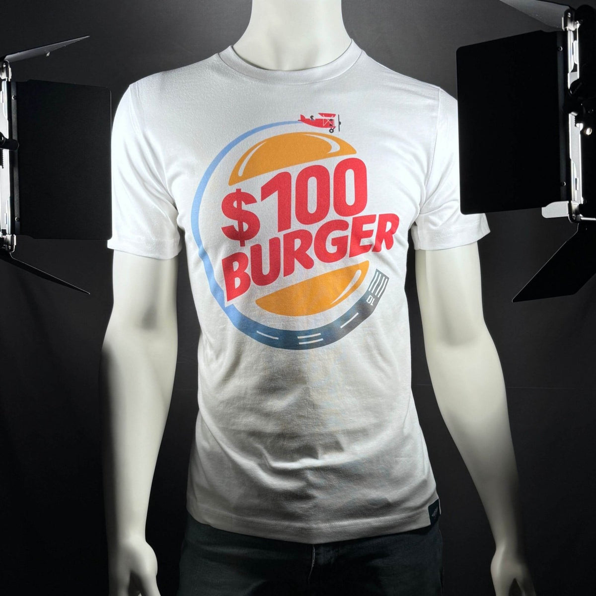 $100 Burger aviation T-shirt displayed on a mannequin