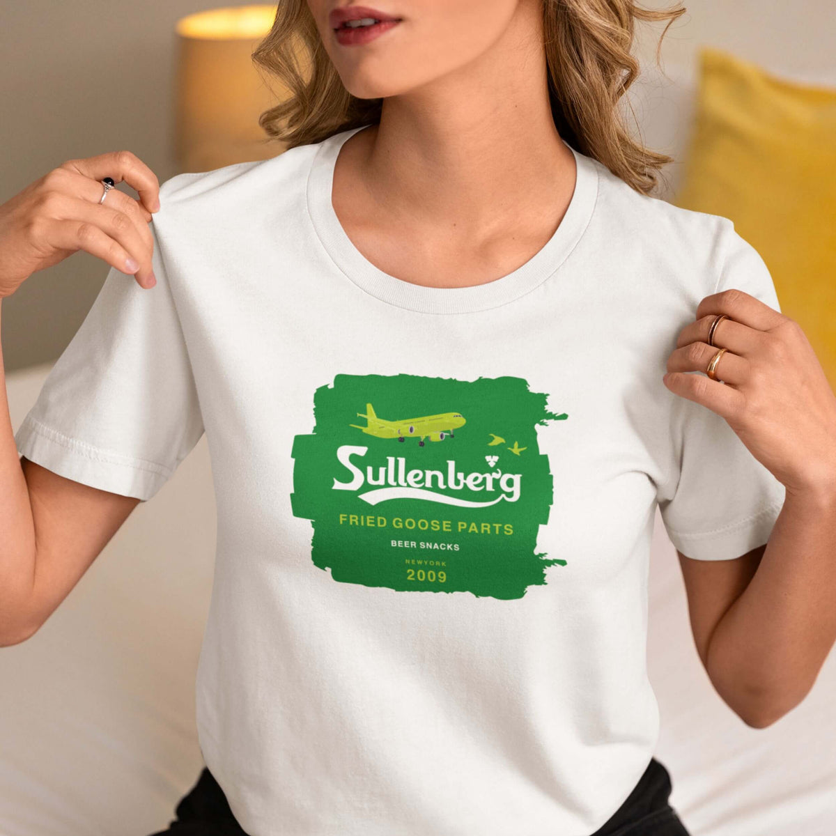 Woman wearing a white Sullenberg pilot T-shirt