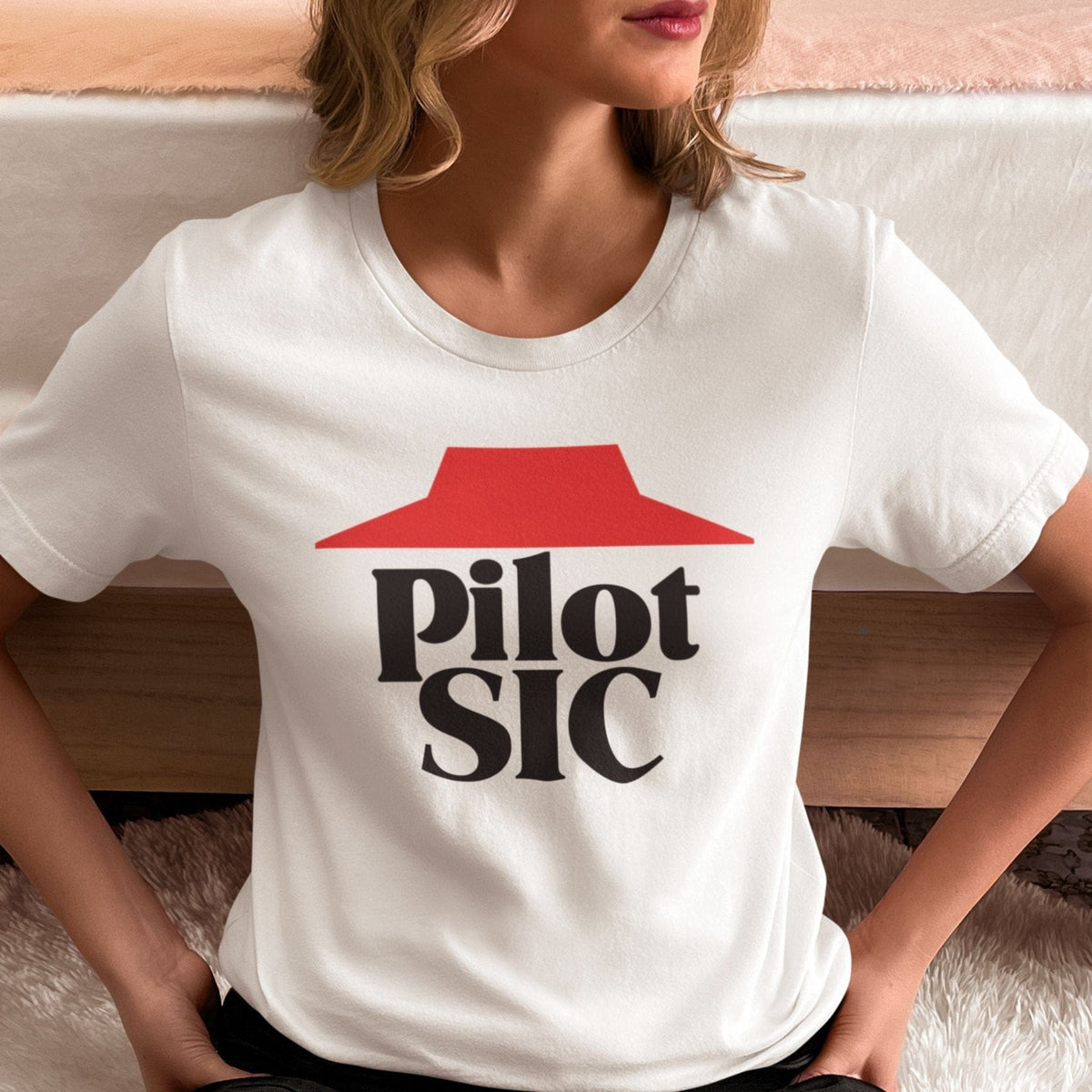 Woman wearing a white Pilot SIC aviation T-shirt