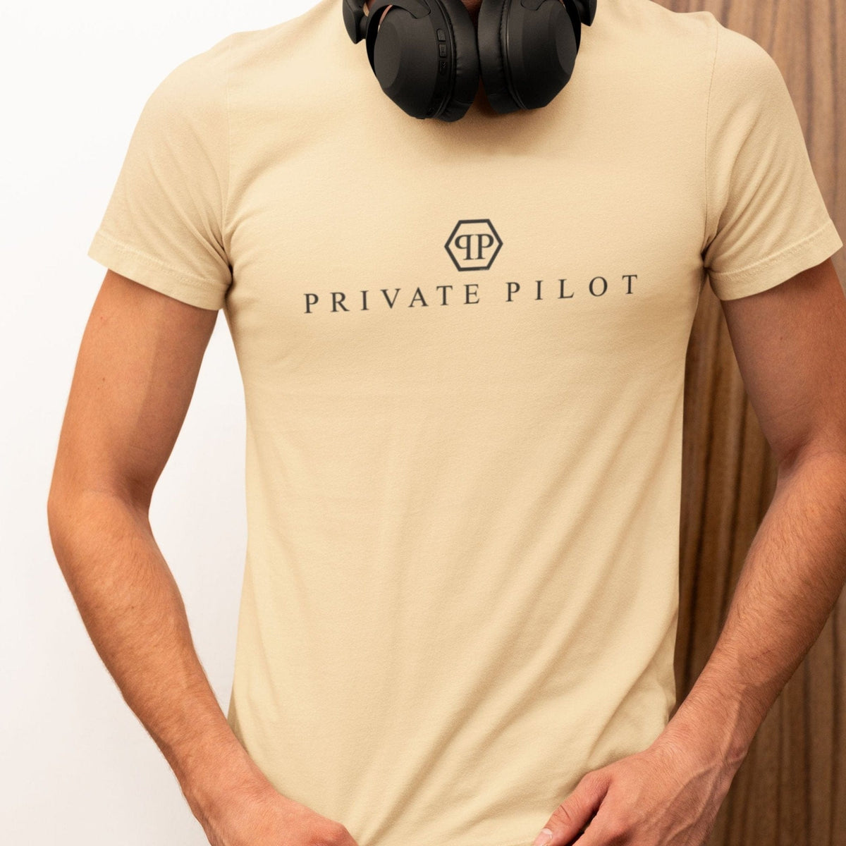 Man wearing a natural Private Pilot logo parody T-shirt