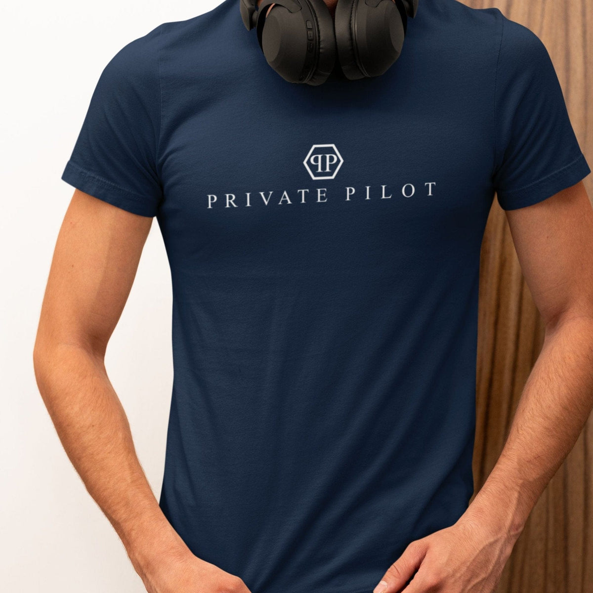 Man wearing a navy Private Pilot logo parody T-shirt