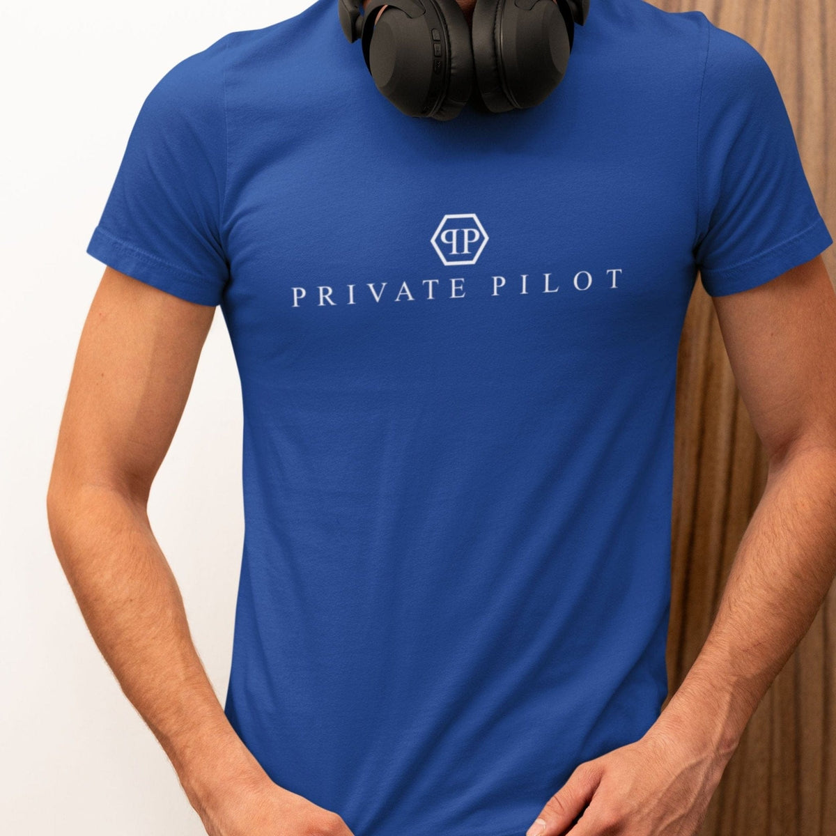 Man wearing a blue Private Pilot logo parody T-shirt