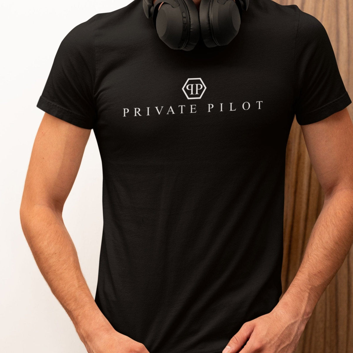 Man wearing a black Private Pilot logo parody T-shirt