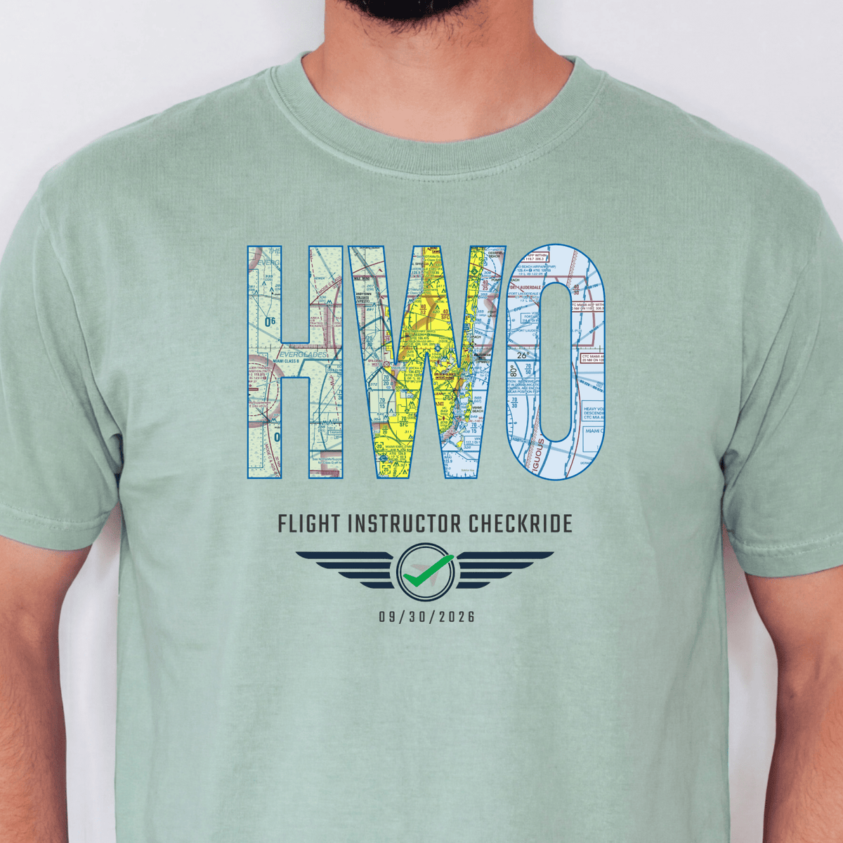 Light green HWO airport code T-shirt with VFR chart lettering and a flight instructor checkride milestone