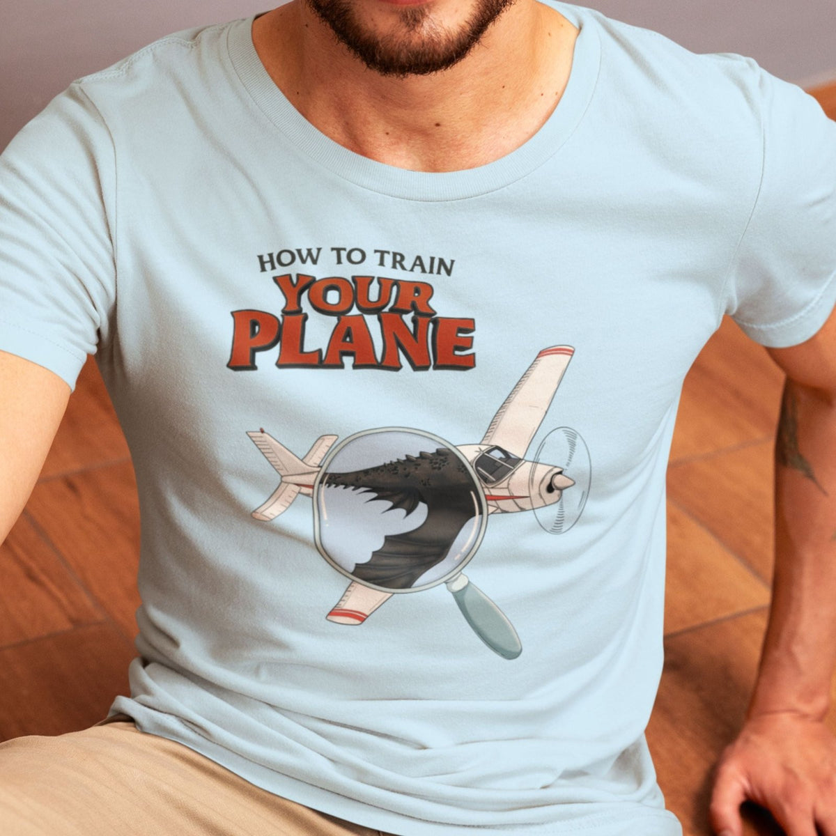 How to Train Your Plane blue T-shirt design close-up