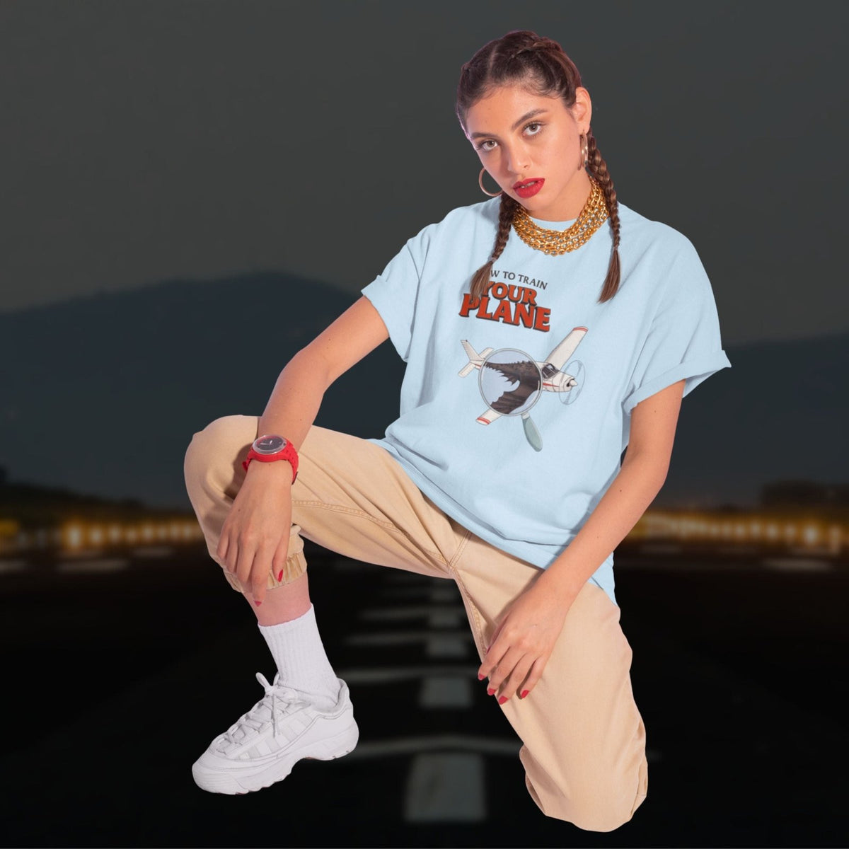 Man wearing a How to Train Your Plane T-shirt seated