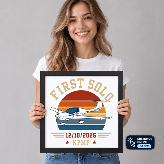 Woman holding a personalized first solo aircraft print in a black frame