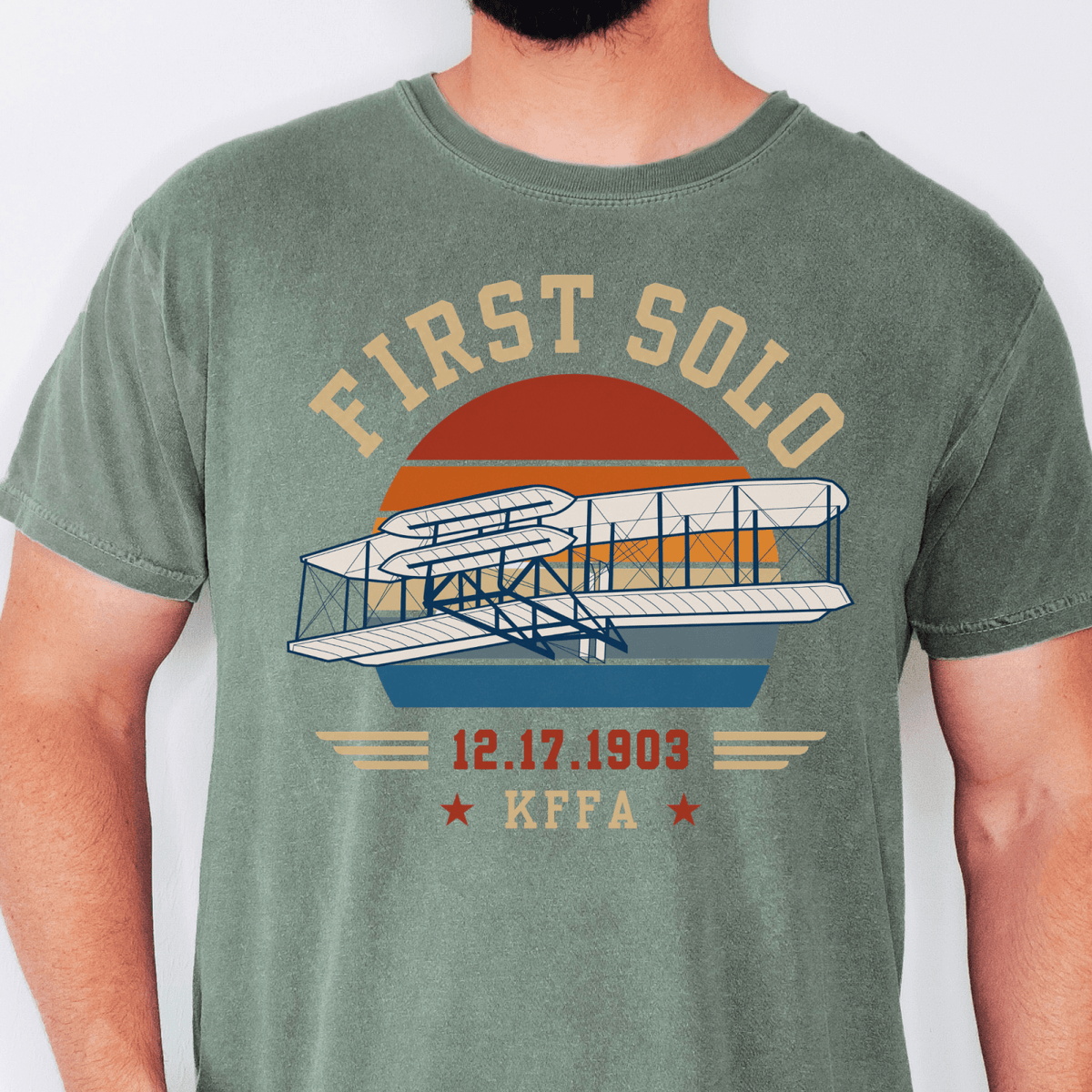 Green First Solo T-shirt featuring the Wright Flyer, the date 12.17.1903, and KFFA airport code