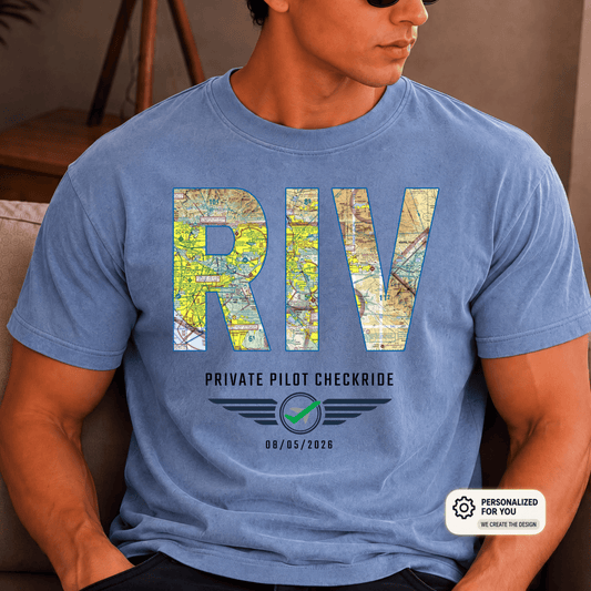 Man wearing a blue VFR chart T-shirt with RIV airport code lettering and a private pilot checkride milestone