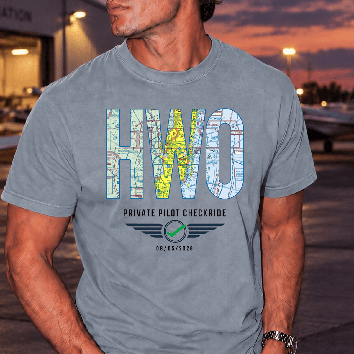 Man wearing a gray HWO airport code T-shirt personalized with a private pilot checkride date