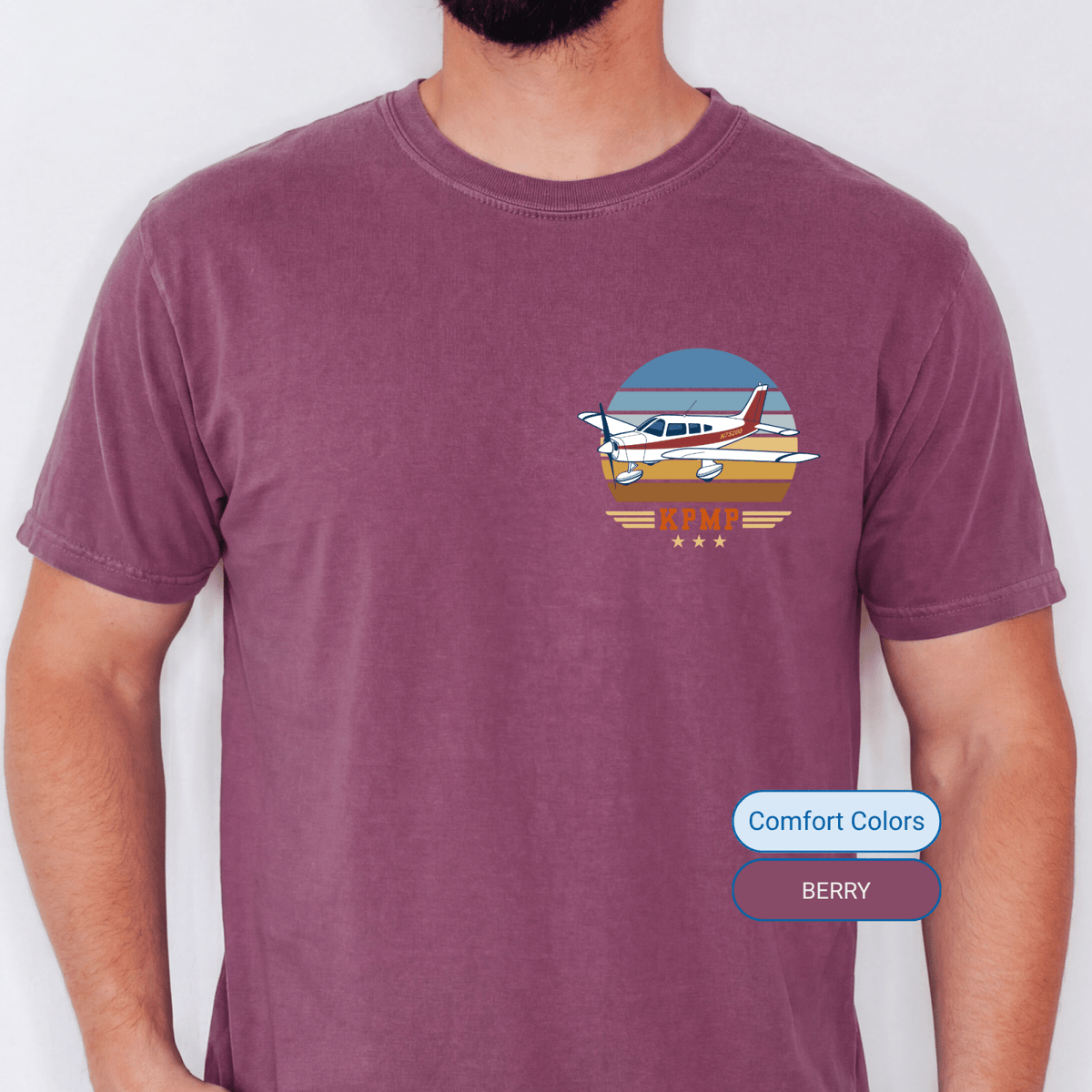 Man wearing a Berry Comfort Colors T-shirt with a personalized Vintage Attitude aircraft graphic